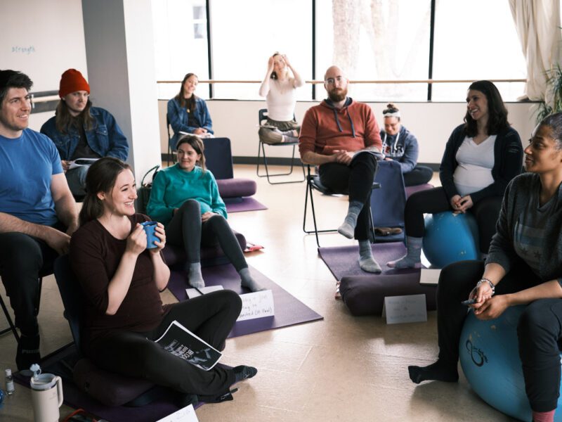 pregnant couples sitting in a birth class in minneapolis, minnesota
