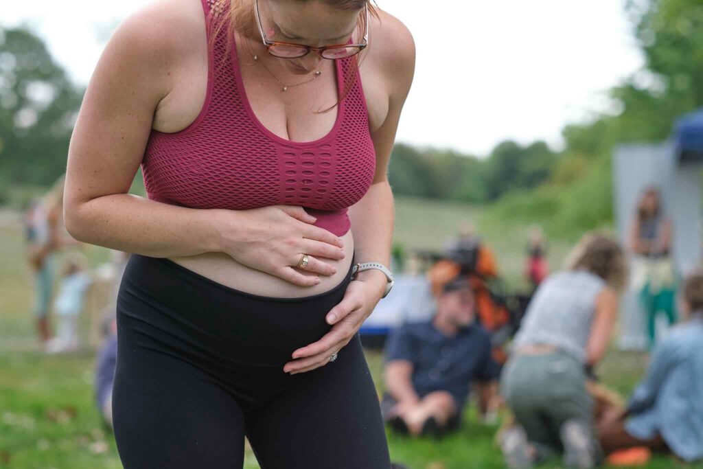 pregnant woman outside at bellyrama doing prenatal yoga