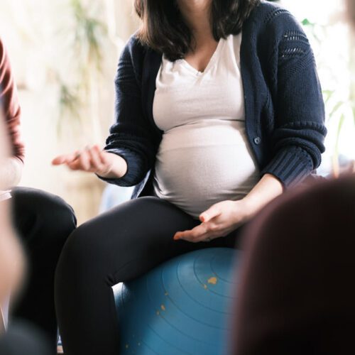 new pregnant mom sitting on a birth ball