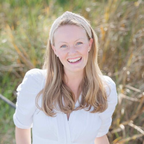 postpartum doula woman hallie wilkening standing in grass