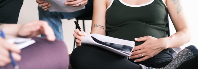 pregnant new mom taking notes in blooma birth class